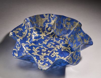 a blue and gold glass bowl with gold leaf designs