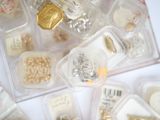 many different types of jewelry in a plastic container