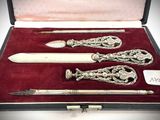a box with a pen, knife, and other items in it