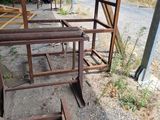 a pile of rusted metal frames sitting on the side of the road