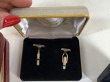 a small box with a pair of cufflinks in it