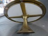 a brass clock with a white face on a table