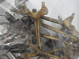 a bunch of brass figurines in a plastic bag
