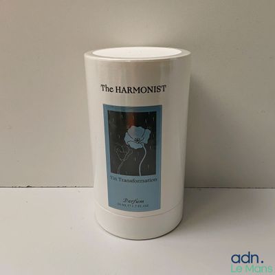 a white cup with a picture of a flower on it