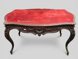 a red table with a red velvet top on it