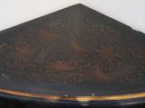 a black table with a brown and gold design on it