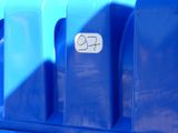 a blue trash can with a sticker on the side of it
