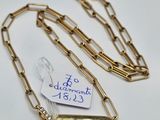 a close up of a gold chain with a tag attached to it