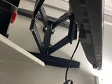 a television that is hooked up to the ceiling