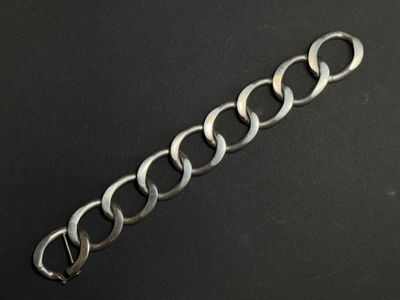 a close up of a metal chain on a black surface