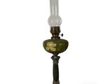 an old fashioned lamp with a glass shade on top of it