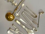 a lot of silver spoons and spoon spoons on the table