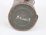 a small metal can with a handle on it that has writing on it