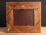 an old wooden picture frame with a rope around it on a table