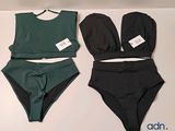 two pieces of swimsuits on a table with tags on them