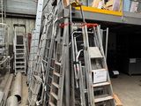 many ladders that are stacked up in a warehouse