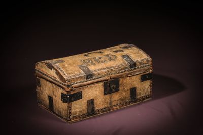 a small wooden chest with a metal latch on it