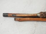 pair of old wooden canes on a white surface