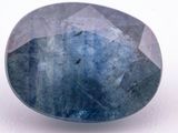 a close up of a blue sapphire stone on a white surface