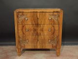 a wooden chest of drawers with carvings on the drawers