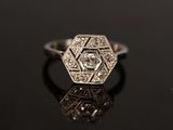 an art deco diamond ring with a central diamond in the center