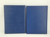 a pair of blue books sitting on top of each other