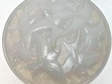 a glass plate with a design on it sitting on a table