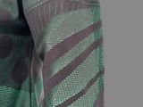 a close up of a camouflage shirt with a green and black pattern