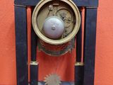 a clock that is sitting on a red table