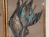 two framed pictures of birds that are on the wall