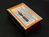 a small box with a pen on top of a table