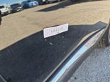 a sticker on the door of a car that is parked in a parking lot