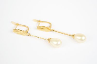 a pair of pearl and gold earrings on a white background