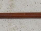 a picture of an old fashioned toothbrush on a wooden table