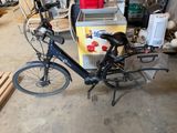 a bike that is parked in a garage with a cooler