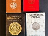 four books on a table with a black table cloth