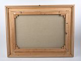 an old picture frame with a picture hanging on the wall
