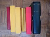 four books in a box on the floor next to each other