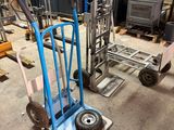 a blue hand truck with wheels in a warehouse