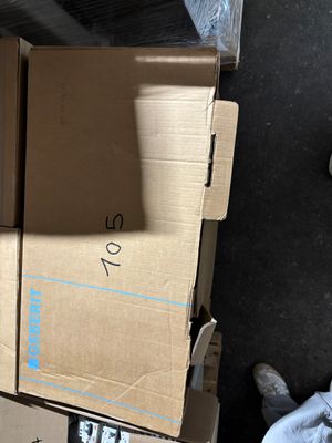 a cat that is sitting on top of a cardboard box