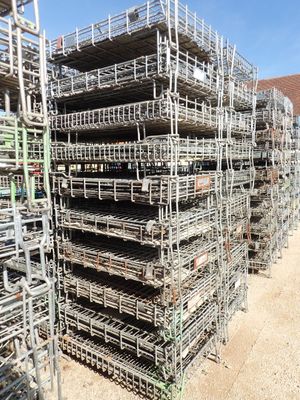 a large pile of scaffolding sitting on top of a dirt field