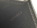 a close up of a black purse with a red handle