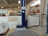an image of a warehouse with a large metal object in the middle of the floor