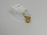 an image of a small gold bell on a white surface