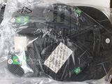 two baseball caps wrapped in plastic bags on a table