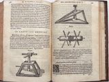 an open book with a drawing of a machine on top of it