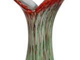 a glass vase with a red and green design on it