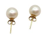 the pearl earrings are gold and have a white pearl on them