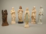 several statues of jesus and other religious figures on a gray background