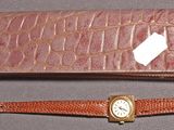 une montre et un portefeuille posés sur une table